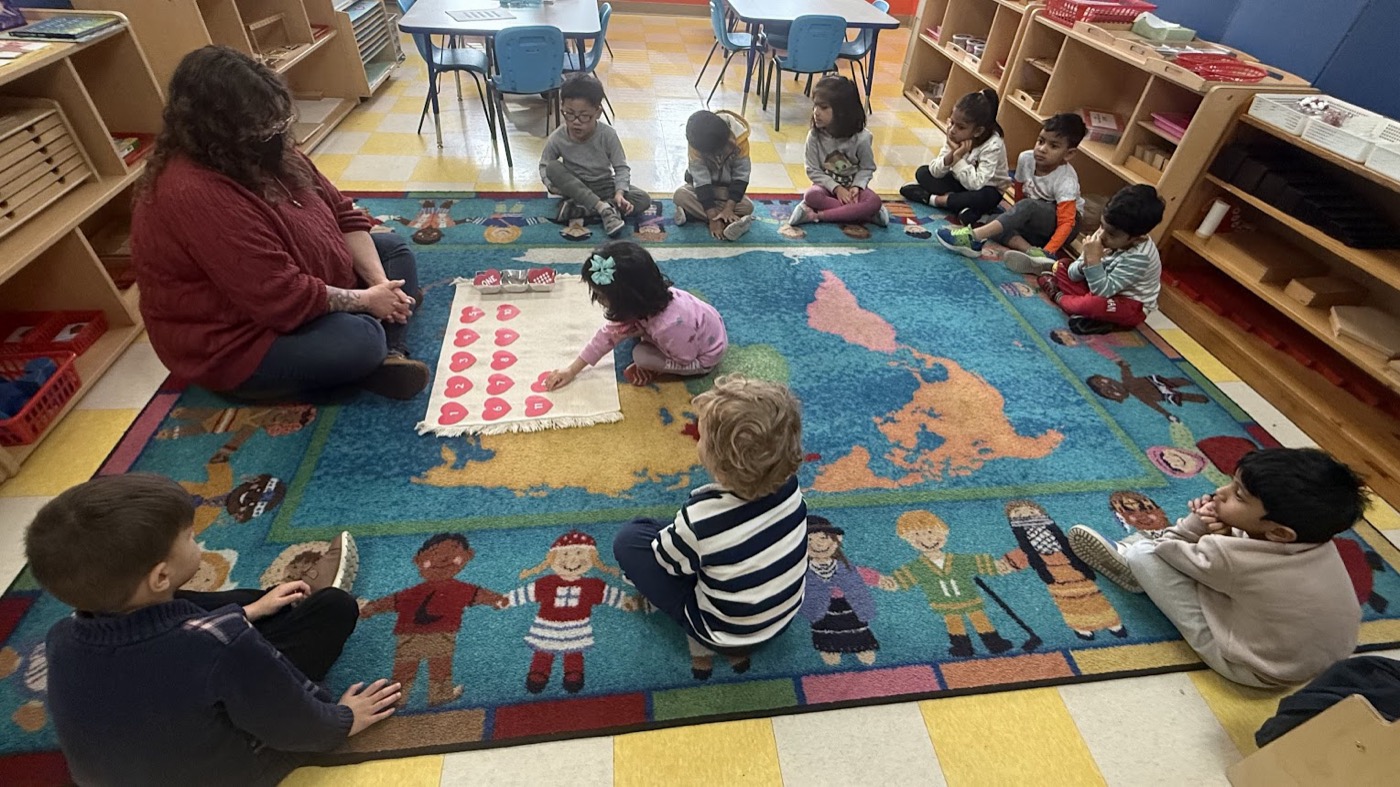 Teacher guiding children during Montessori circle time