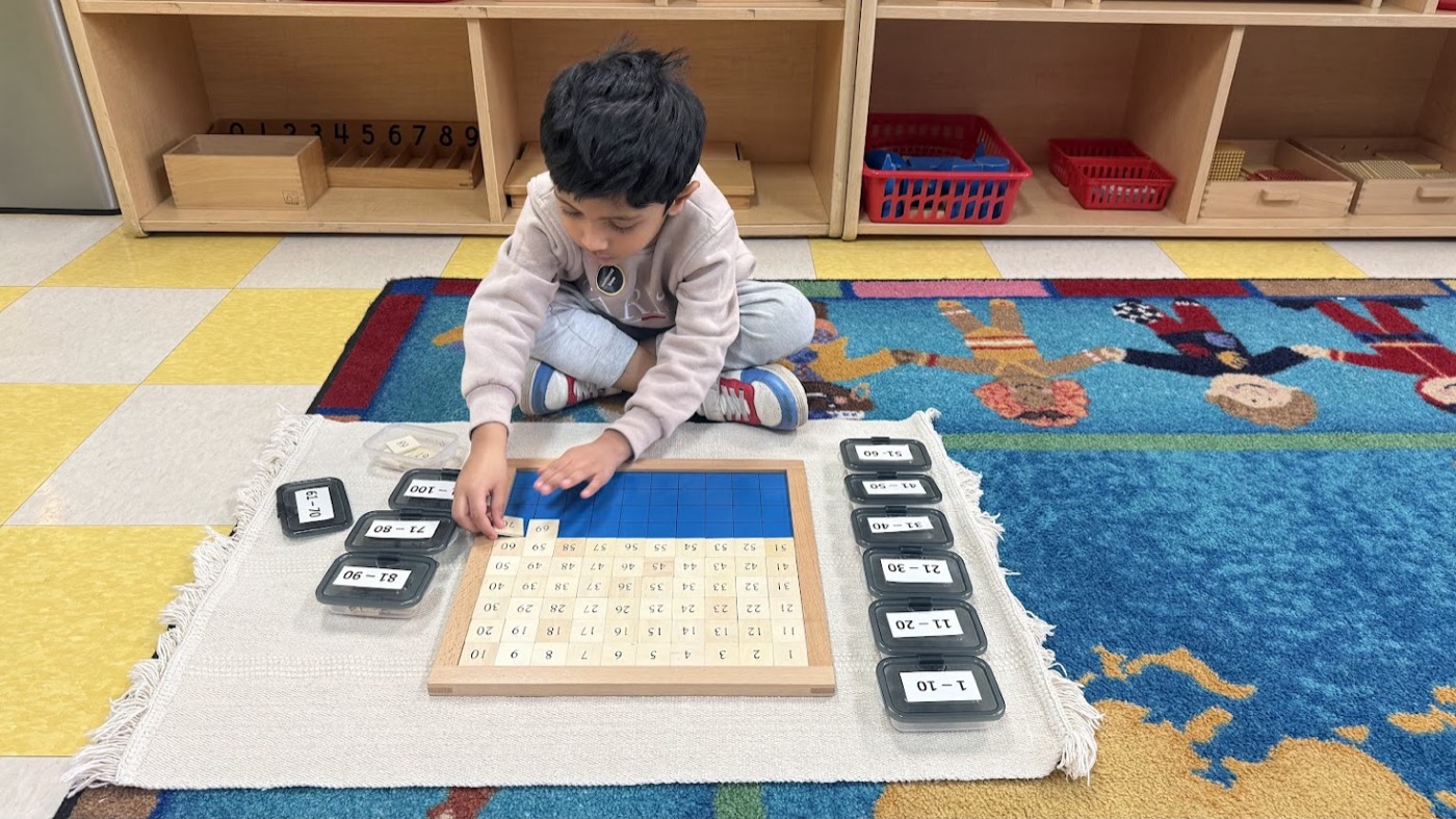 Child working with Montessori math materials