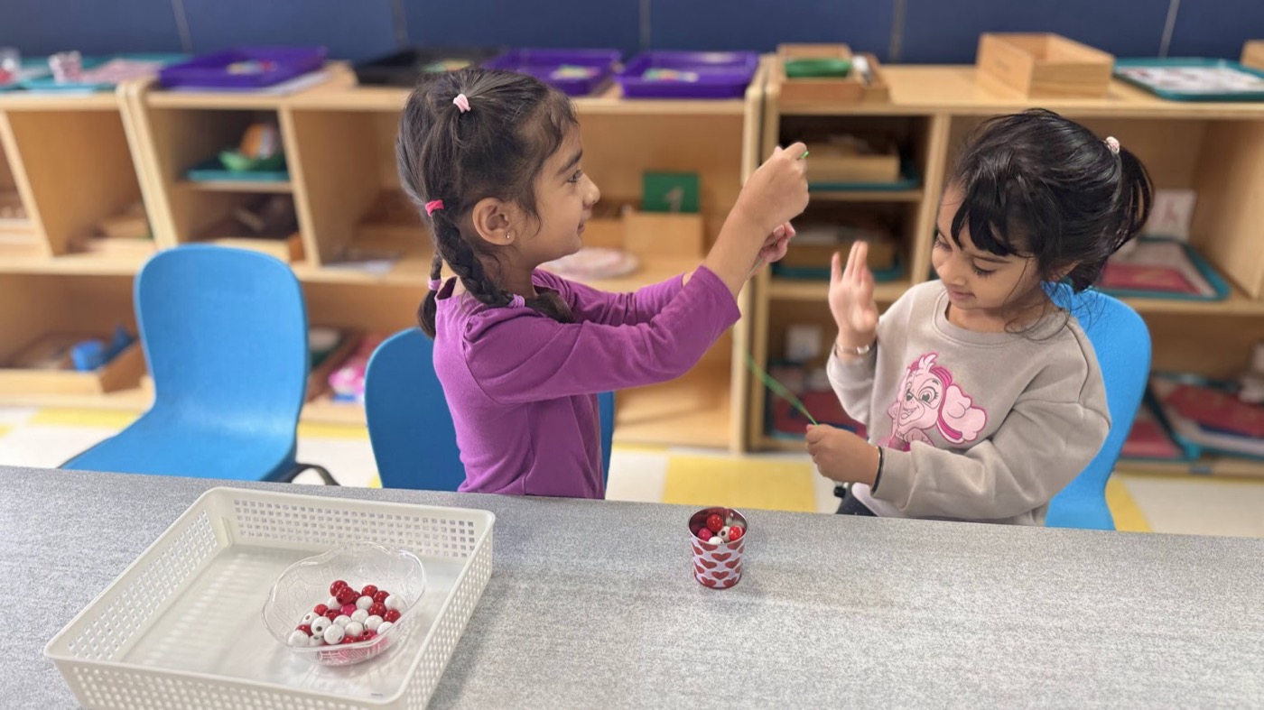 Children working together with Montessori classroom materials