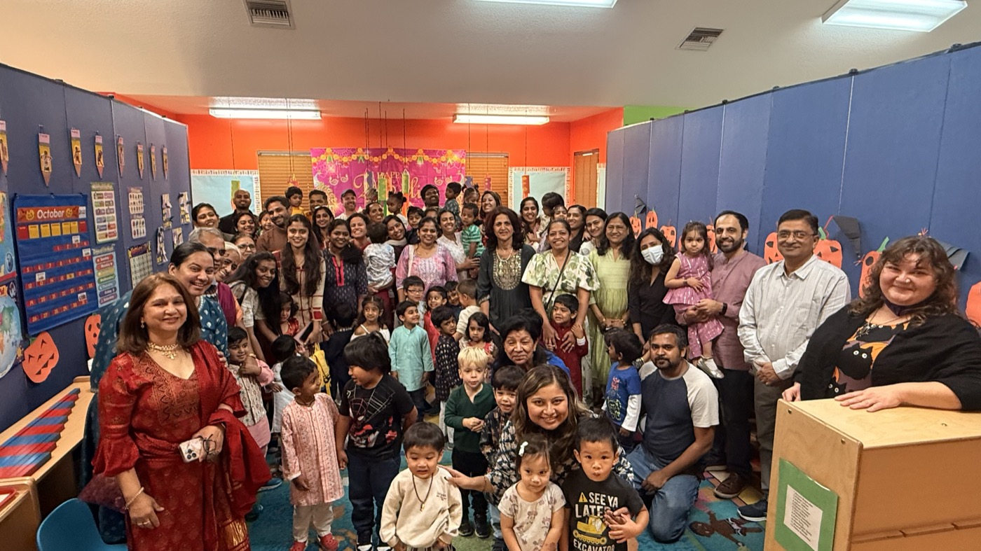 Over the Rainbow Montessori families and teachers gathered in a classroom