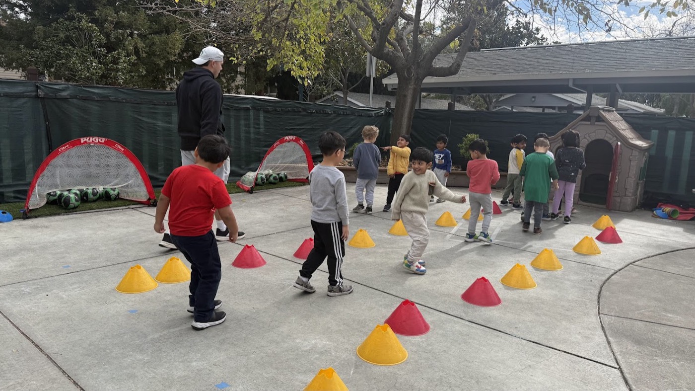 Over the Rainbow Montessori children enjoying outdoor soccer play